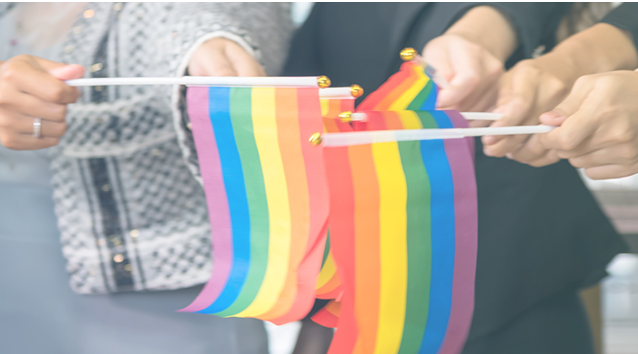 People holding rainbow flags together